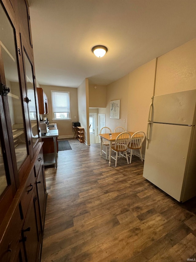 dining space with dark hardwood / wood-style flooring