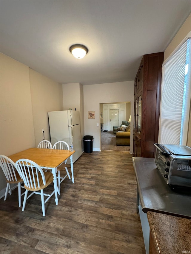 dining space with dark hardwood / wood-style flooring