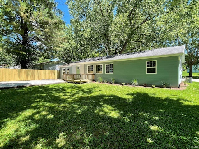 back of house with a yard and a deck