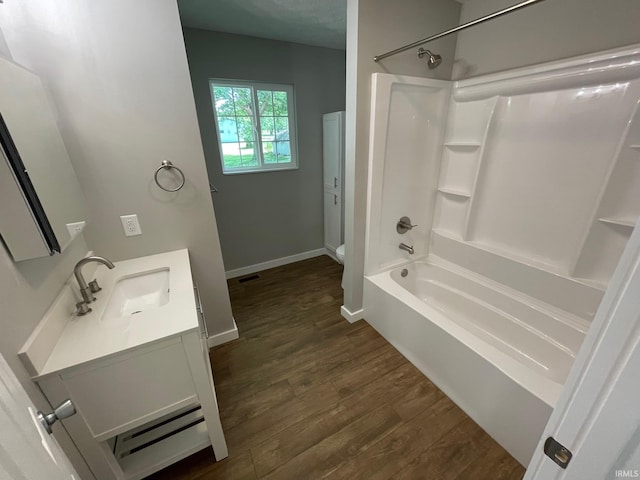 bathroom featuring hardwood / wood-style floors, shower / bath combination, and vanity