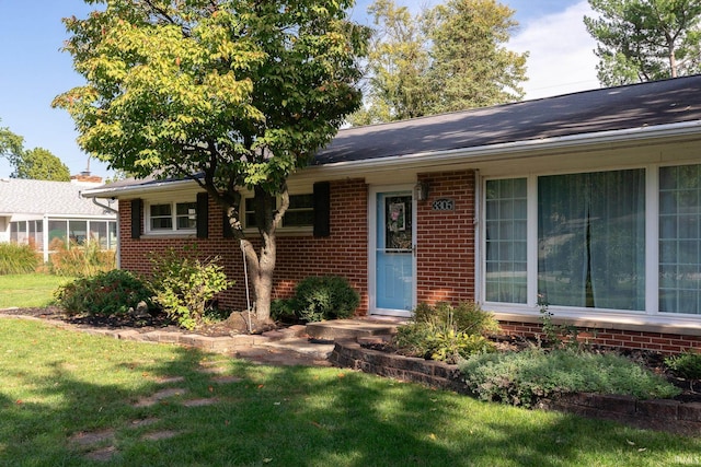 ranch-style home with a front lawn