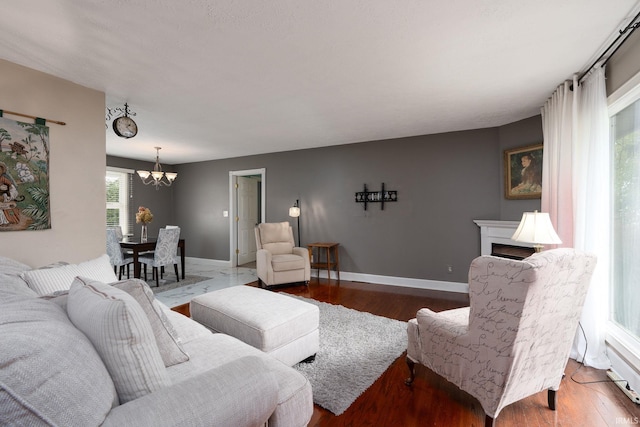 living room with a notable chandelier and dark hardwood / wood-style flooring