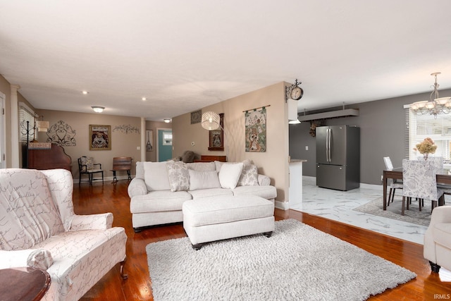 living room featuring a chandelier and dark wood-type flooring