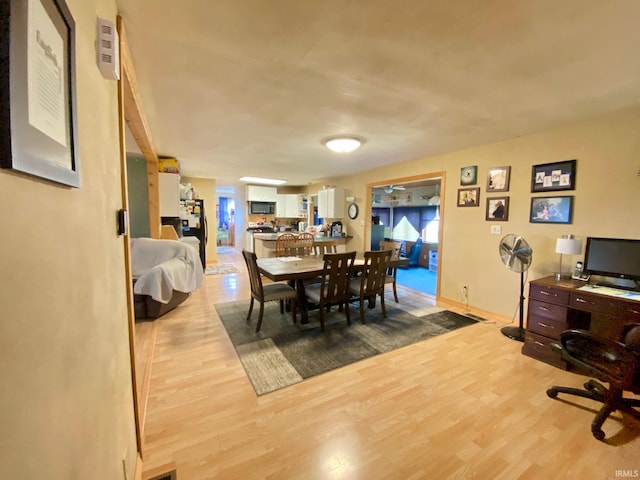 dining space with light wood-type flooring