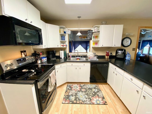 kitchen featuring sink, white cabinets, kitchen peninsula, light hardwood / wood-style flooring, and black appliances