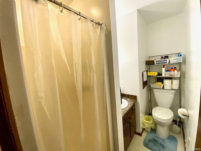 bathroom with curtained shower, vanity, toilet, and tile patterned floors