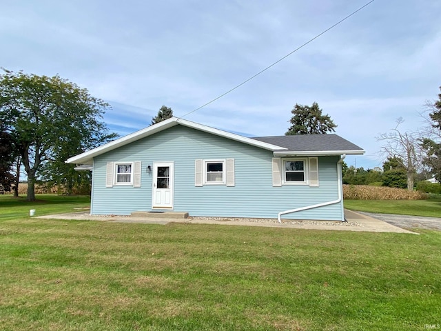 back of property featuring a yard