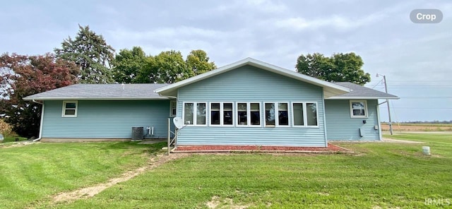 back of house featuring a yard and central AC unit