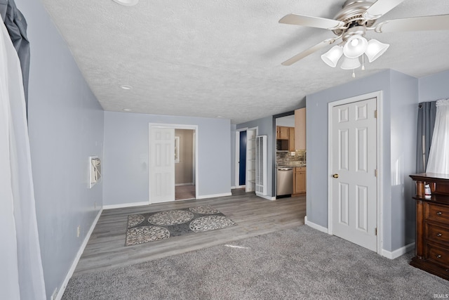 interior space featuring ceiling fan, a textured ceiling, and light hardwood / wood-style flooring