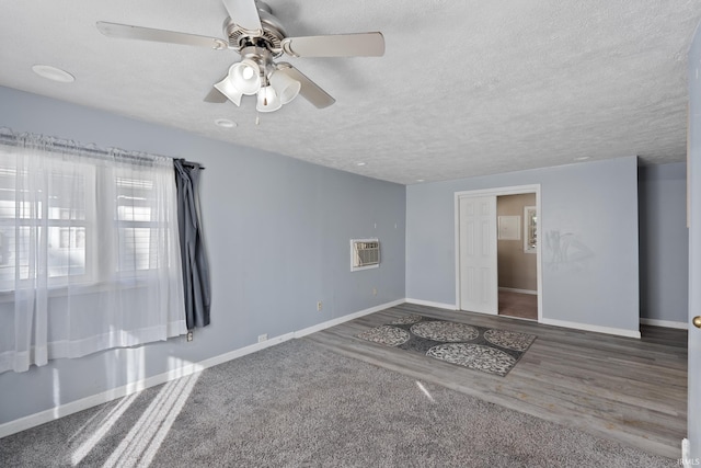 unfurnished room featuring ceiling fan, hardwood / wood-style flooring, and a textured ceiling