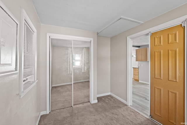 unfurnished bedroom featuring a textured ceiling and light carpet