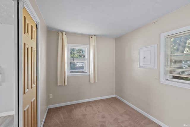 carpeted empty room featuring a textured ceiling