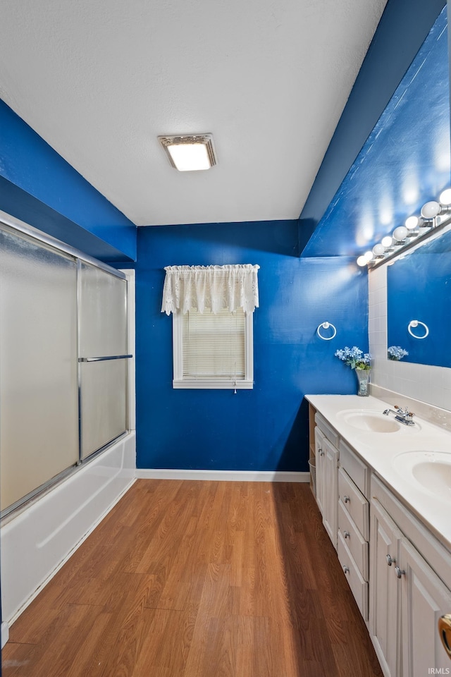 bathroom featuring vanity, shower / bath combination with glass door, and hardwood / wood-style flooring