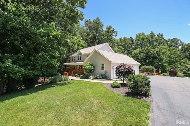 view of side of property with a yard and a garage