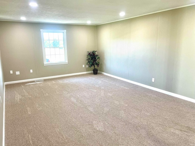 empty room featuring a textured ceiling and carpet