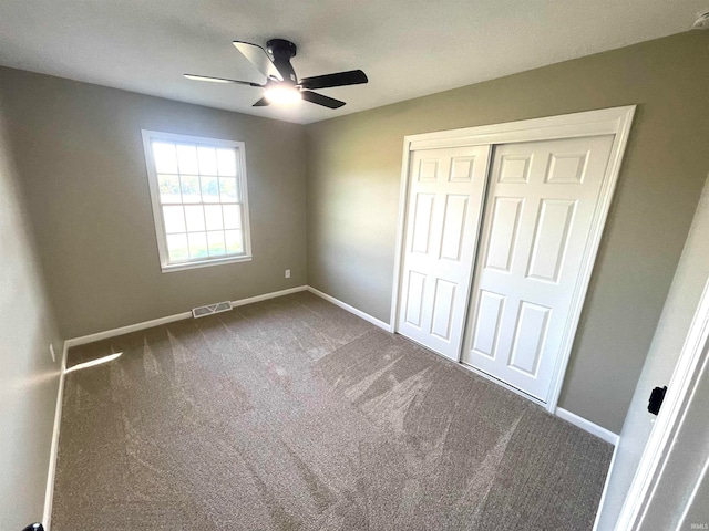 unfurnished bedroom with carpet, ceiling fan, and a closet