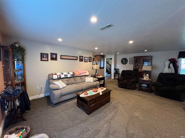 living room featuring carpet floors and a textured ceiling