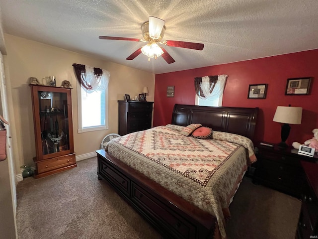 carpeted bedroom featuring ceiling fan and a textured ceiling