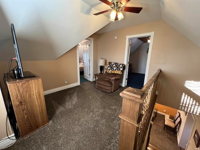 additional living space featuring vaulted ceiling, dark colored carpet, and ceiling fan