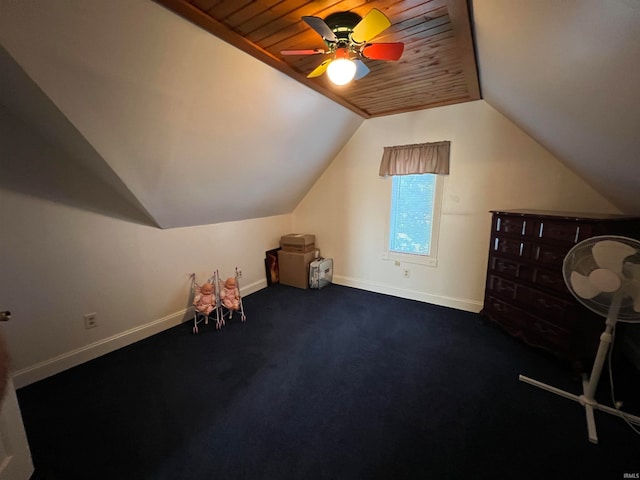 additional living space featuring wood ceiling, vaulted ceiling, ceiling fan, and dark carpet