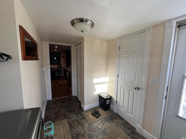 entrance foyer featuring a textured ceiling and dark hardwood / wood-style floors