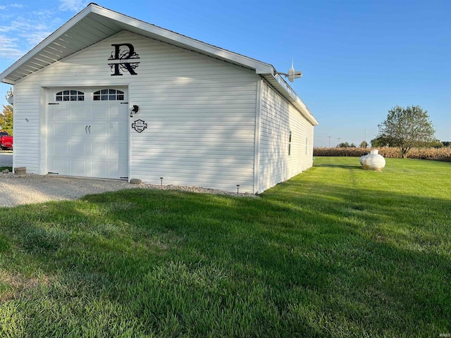 view of home's exterior featuring an outbuilding, a yard, and a garage