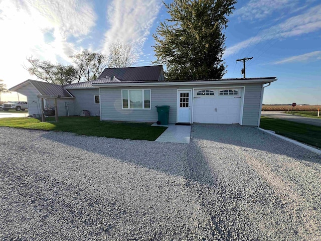 ranch-style house featuring a front yard and a garage