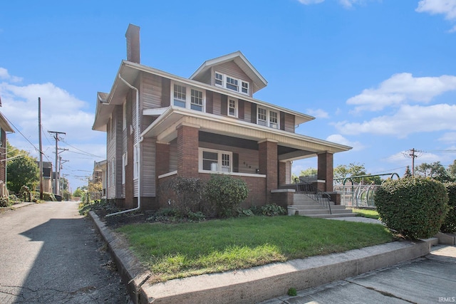 view of front of home with a front yard and a porch