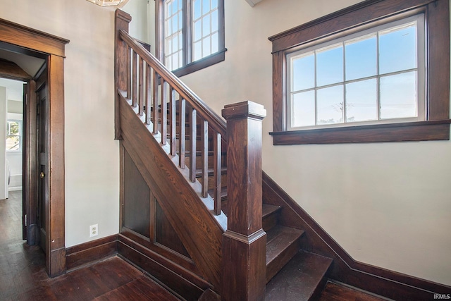 stairs featuring hardwood / wood-style flooring and a wealth of natural light