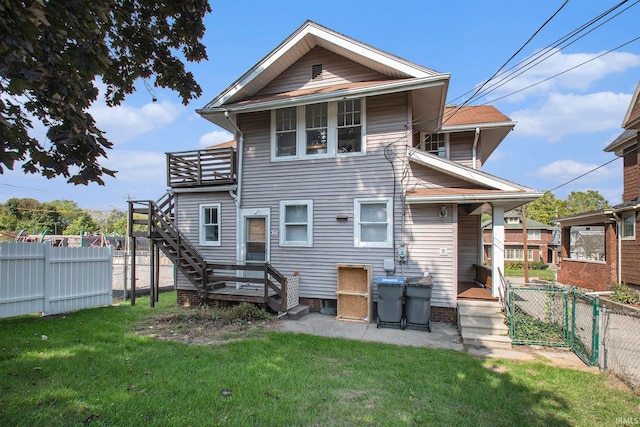 rear view of house featuring a yard