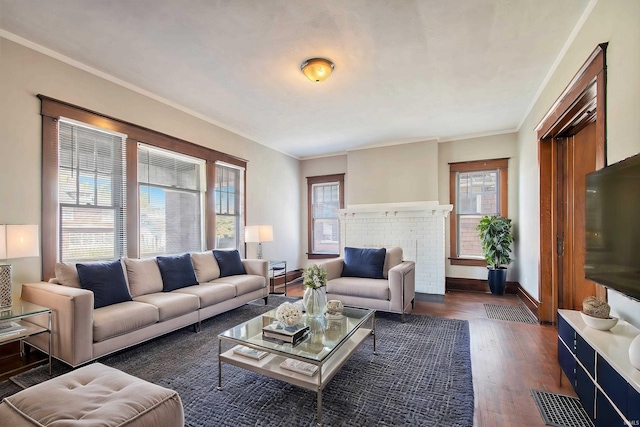 living room with ornamental molding, a fireplace, and dark hardwood / wood-style flooring