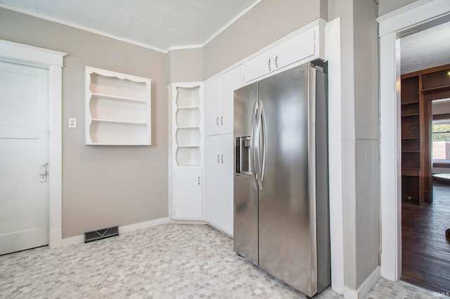 kitchen with light wood-type flooring, crown molding, white cabinetry, and stainless steel fridge with ice dispenser