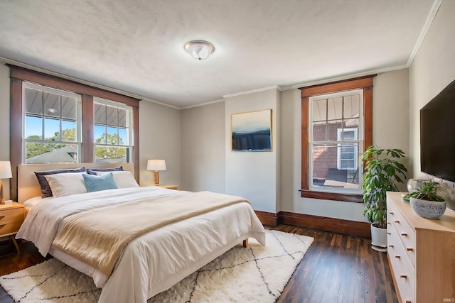 bedroom with a textured ceiling, ornamental molding, and dark hardwood / wood-style flooring