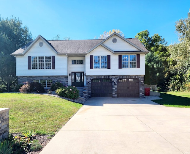 raised ranch with a garage and a front yard