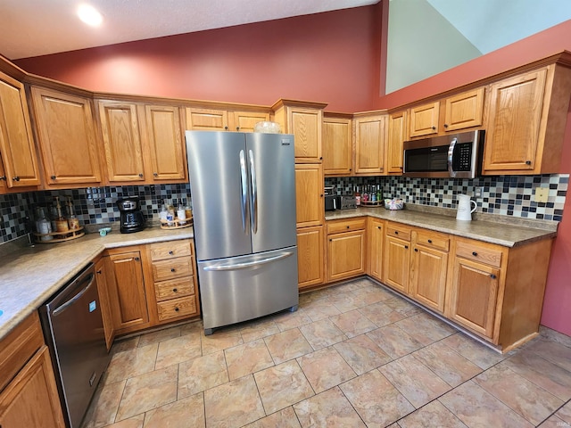 kitchen featuring stainless steel appliances, backsplash, and high vaulted ceiling