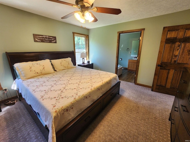 bedroom with ceiling fan, ensuite bath, and carpet flooring