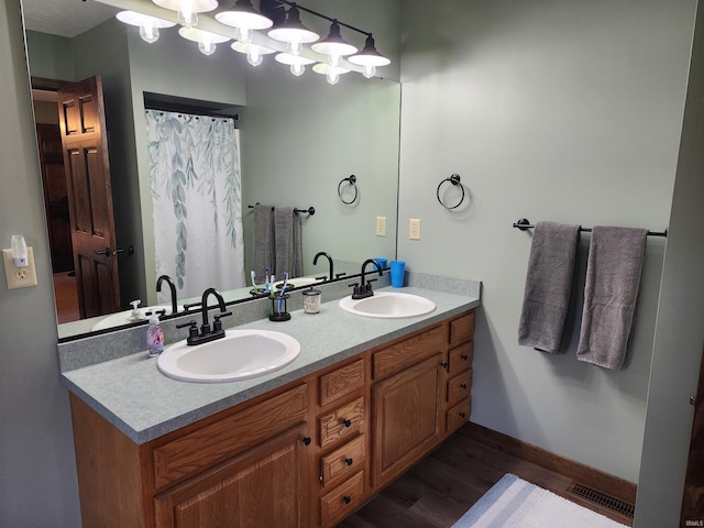 bathroom featuring vanity and hardwood / wood-style flooring