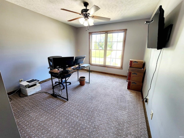 home office featuring a textured ceiling, ceiling fan, and carpet floors