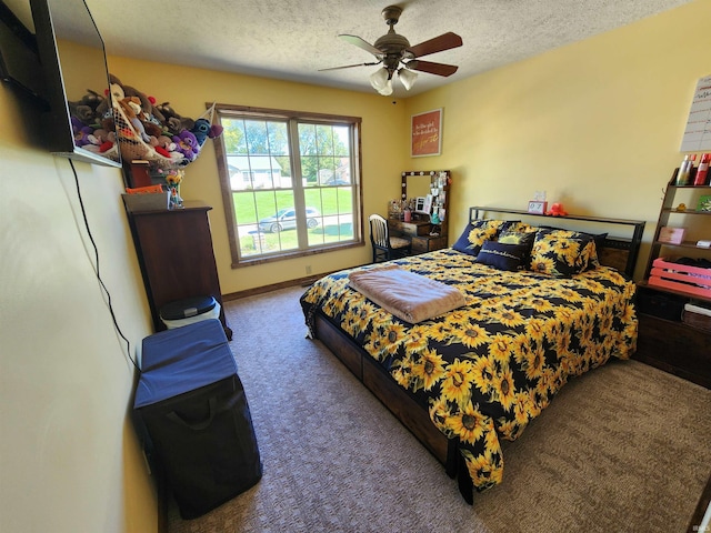 bedroom featuring ceiling fan, carpet flooring, and a textured ceiling