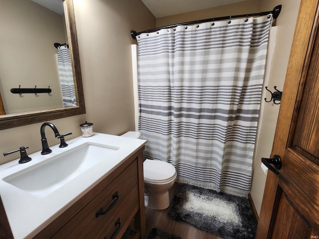 bathroom featuring vanity, hardwood / wood-style floors, toilet, and a shower with shower curtain