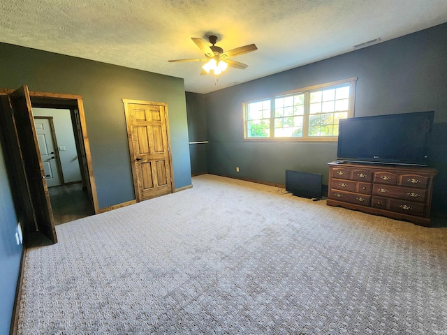 carpeted bedroom with a textured ceiling and ceiling fan