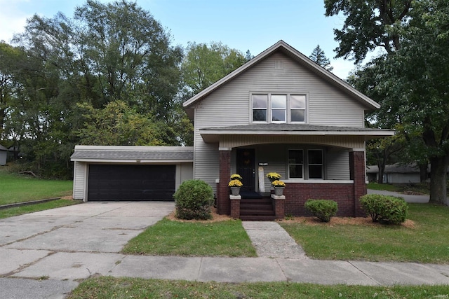 view of front facade featuring a front yard, a garage, and a porch