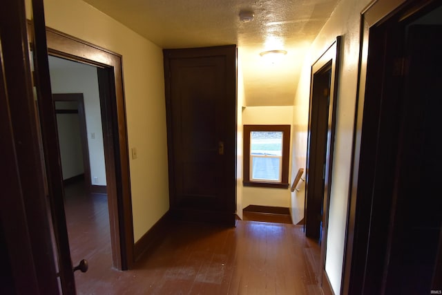 hallway featuring hardwood / wood-style flooring and a textured ceiling