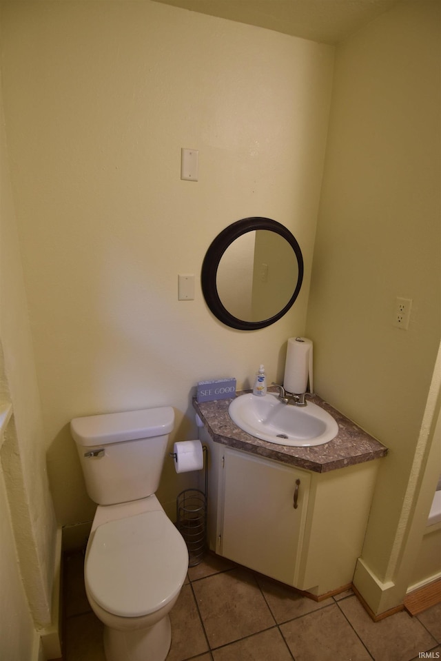 bathroom with vanity, tile patterned flooring, and toilet