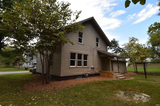 rear view of property with a yard