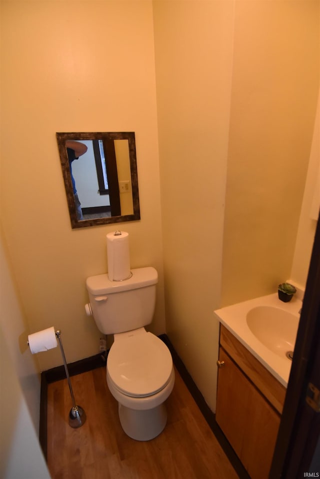 bathroom featuring hardwood / wood-style floors, vanity, and toilet