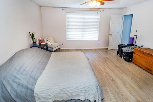 bedroom with light wood-type flooring and ceiling fan