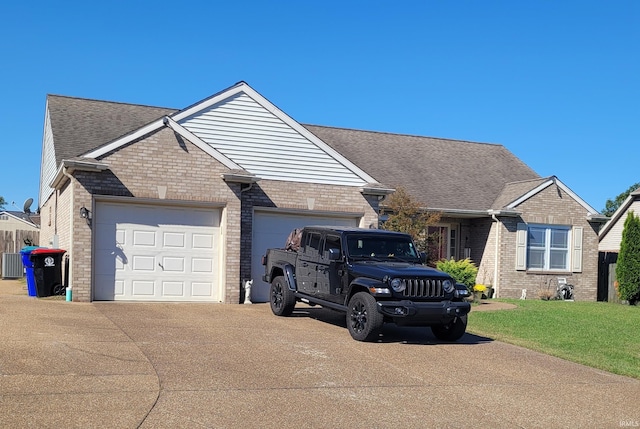 ranch-style home with a front yard, a garage, and central AC unit