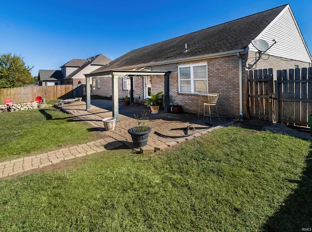 rear view of property with a patio area and a yard