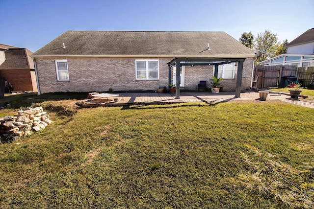 rear view of house featuring a patio area and a lawn